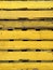 Closeup of several yellow wooden pallets