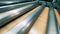 Closeup of sheet metal with wood grain coating moving through rolling mill