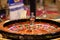 Closeup of shiny wooden roulette in casino, selective focus