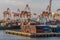 Closeup of Shipping containers, multiple cranes and ships in Manila, Philippines