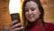 Closeup shoo9t of young pretty overweight caucasian female using the phone indoors in a cozy apartment