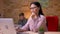 Closeup shoot of adult asian businesswoman working on the laptop indoors in the office. Businessman handling her graphs