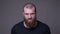 Closeup shoot of adult handsome muscular caucasian man with beard being angry looking at camera with background isolated