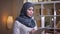 Closeup shoot of adult muslim businesswoman studying the graph in the library and looking for a solution for problem on