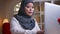 Closeup shoot of adult muslim businesswoman typing on the laptop being busy and concentrated on the workplace indoors