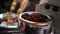 Closeup shoot of coffee beans being freshly grinded in a coffee blending machine indoors in a cafe