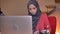 Closeup shoot of group of three young muslim female employees in hijabs working in office. One office worker drinking