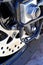 Closeup Shoot of Moto Rear Wheel Brake Disk with ABS Sensor and Brake Pistons