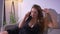 Closeup shoot of plump sexy pretty caucasian female with big breasts having a talk on the phone while resting on the