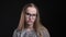 Closeup shoot of young attractive hipster female in glasses frowning being skeptical and frustrated looking straight at