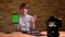 Closeup shoot of young attractive hipster female video blogger streaming live using the tablet and showing green screen