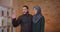 Closeup shoot of young attractive muslim couple house planning and settling in a newly bought apartment indoors