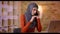 Closeup shoot of young attractive muslim female employee in hijab having a conversation on the phone while typing on the