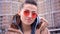 Closeup shoot of young attractive trendy caucasian girl in red sunglasses with ponytail smiling and looking at camera