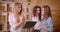 Closeup shoot of young beautiful lesbian couple having a discussion with female realtor about purchase of an apartment