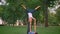 Closeup shoot of young female and male training acroyoga star pose in the park. Woman being raised up on mans toes and