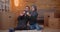 Closeup shoot of young happy muslim couple sitting on the floor next to the boxes in a newly bought apartment using the