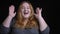 Closeup shoot of young overweight caucasian female dancing and laughing cheerfully in front of the camera