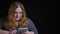 Closeup shoot of young overweight caucasian female typing on the tablet then looking at camera and smiling