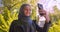 Closeup shoot of young pretty muslim female in hijab taking selfies on the phone smiling happily in the urban city