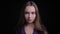 Closeup shoot of young stunning caucasian female with long brunette hair looking straight at camera with background