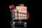 Closeup shopping cart with sale paper bags is isolated on black