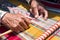 Closeup shot of an aged female sewing a beautiful embroidery product