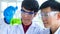 Closeup shot of Asian happy young successful professional male scientist student face in white lab coat and blue rubber gloves