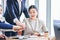 Closeup shot Asian professional successful female businesswoman sitting smiling with unrecognizable male businessmen employee