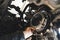 closeup shot of an auto mechanic installing a new clutch kit for a car, auto repair shop