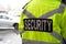 Closeup shot of a back of security guard watching over a parking area