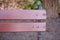 Closeup shot of the backrest of a wooden bench with a blurred background