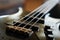 Closeup shot of a bass guitar bridge - Fender Jazz Bass style bridge