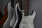 Closeup shot of the beautiful gray electric guitars leaned on the wall