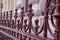 Closeup shot of the beautiful metal fences in front of a stone building