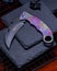 Closeup shot of a beautiful pocket knife with an abstract colorful design on the handle