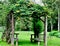 Closeup shot of a beautiful rustic wooden arbor with seats covered in honeysuckle vines