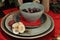 Closeup shot of berries in a ceramic bowl and decorative flowers on the plates