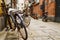 Closeup shot of a bike in a narrow street in Shanghai with scooters in the blurred background