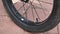 Closeup shot of a bike wheel on a tiled ground