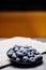 Closeup shot of a black ceramic plate with fresh organic blueberries from the Ecuadorian highlands.