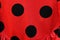 Closeup shot of black dots on a red flamenco dress textile