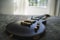 Closeup shot of a black electric guitar on a bed with patterned sheet