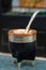 Closeup shot of a black mate cup with mate bombilla straw.