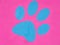 Closeup shot of a blue animal footprint on a bright pink background