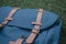 Closeup shot of a blue backpack with a closed pocket on a blurred background