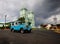 Closeup shot of a blue classic Landrover Defender on a Sarchi church