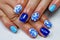 Closeup shot of a blue professional modern gel manicure