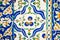 Closeup shot of blue, white and orange colored ornamental ceramic tile
