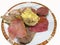 Closeup shot of boiled  tongue meat, chicken meat, and  cotechino pork  on a white background